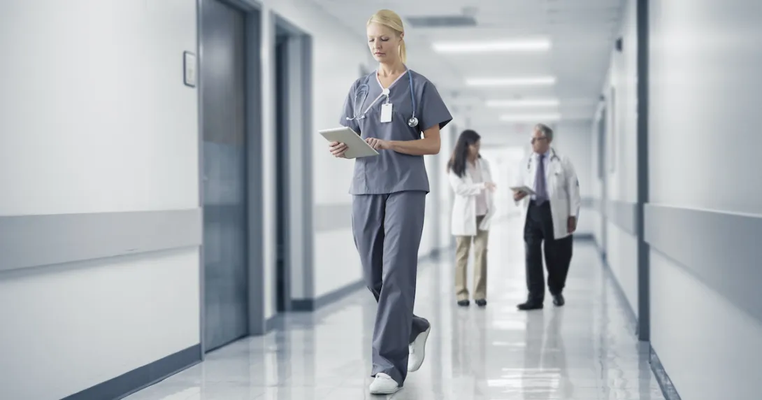 A nurse reading a patient's chart on a digital tablet A nurse reading a patient's chart on a digital tablet